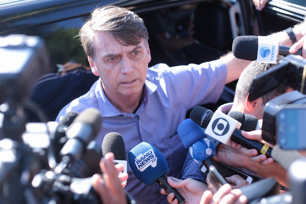 Jair Bolsonaro (PSL), fala com a imprensa na porta do carro