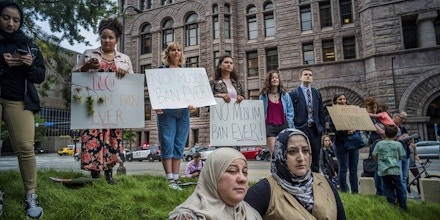 Protesters who started at the Federal Courthouse demonstrate in the street to show their opposition at the Supreme Court's decision to uphold the Trump administration's travel ban Tuesday, June 26, 2018, in Minneapolis. Muslim individuals and groups, as well as other religious and civil rights organizations, expressed outrage and disappointment at the U.S. Supreme Court's decision Tuesday to uphold President Donald Trump's ban on travel from several mostly Muslim countries. (Richard Tsong-Taatarii/Star Tribune via AP)
