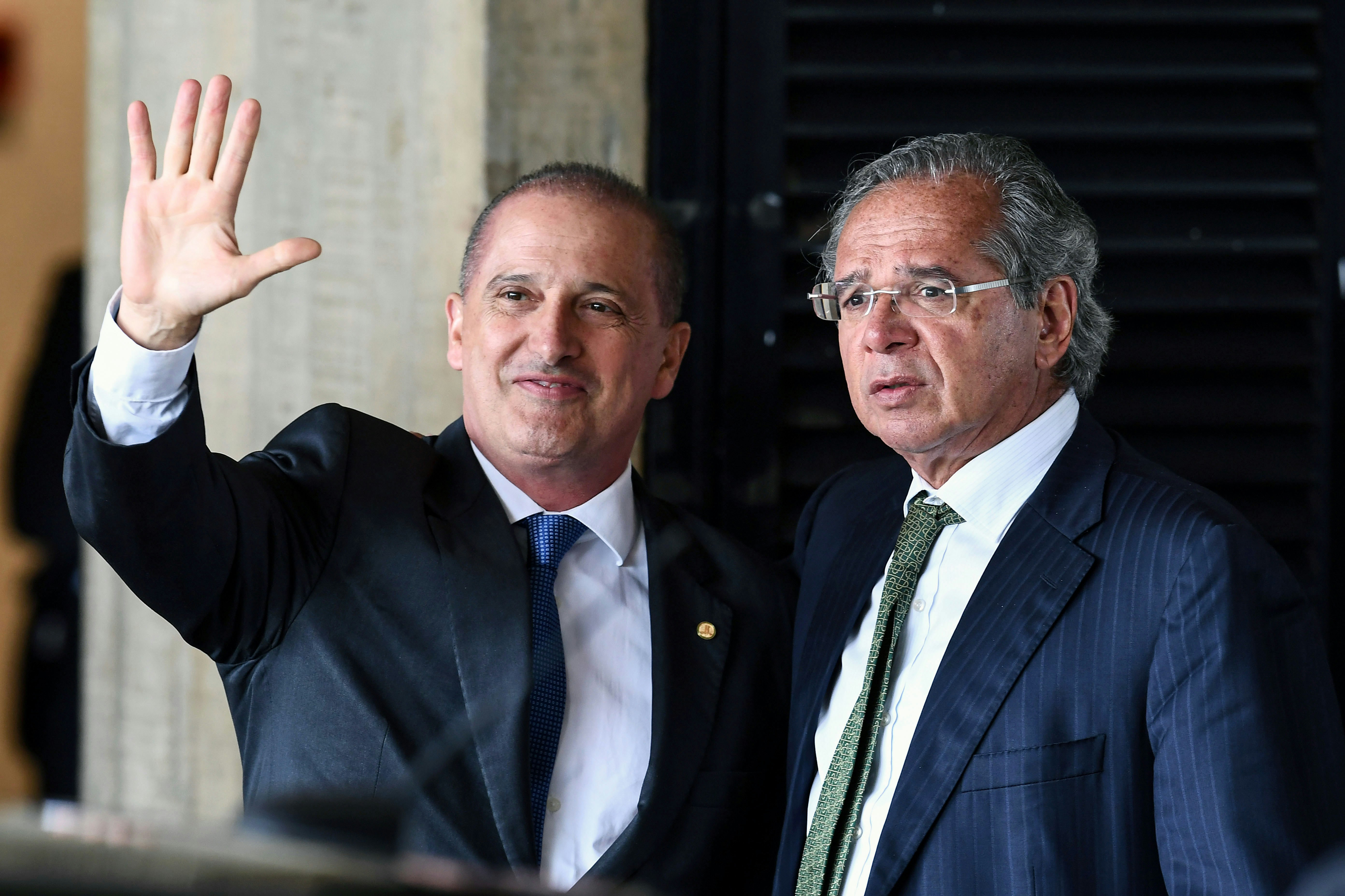 Onyx Lorenzoni (L), the future Chief of Staff of Brazilian president-elect Jair Bolsonaro's government and Paulo Guedes, who was appointed as Finance Minister gesture uppon arrival at the transitional government's headquarters in Brasilia on November 21, 2018. (Photo by EVARISTO SA / AFP)        (Photo credit should read EVARISTO SA/AFP/Getty Images)