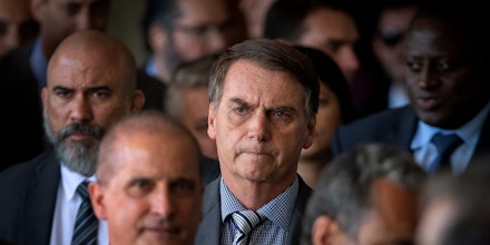 The president-elect of Brazil, Jair Bolsonaro (C), arrives for a press conference on the appointment of the ministers of Citizenship, Tourism and Regional Development at the headquarters of the transitional government in Brasilia on November 28, 2018. (Photo by Sergio LIMA / AFP) (Photo credit should read SERGIO LIMA/AFP/Getty Images)