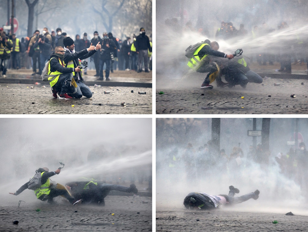 Manifestantes “gilet jaune” são atingidos por um canhão de água policial durante um protesto em Paris, em 12 de janeiro de 2019.