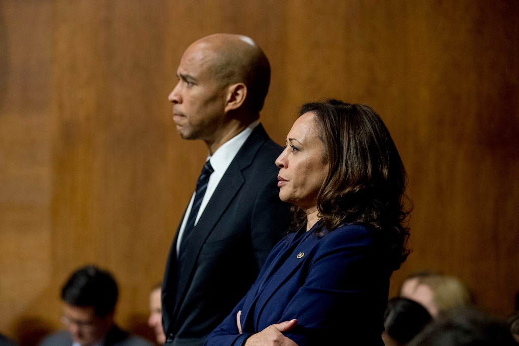 Sen. Cory Booker, D-N.J., and Sen. Kamala Harris, D-Calif., listen as Sen. Jeff Flake, R-Ariz., speaks during a Senate Judiciary Committee hearing on Supreme Court nominee Judge Brett Kavanaugh, Friday, Sept. 28, 2018, on Capitol Hill in Washington. The committee advanced Brett Kavanaugh's nomination for the Supreme Court after agreeing to a late call from Sen. Jeff Flake, R-Ariz., for a one week investigation into sexual assault allegations against the high court nominee. (AP Photo/Andrew Harnik)