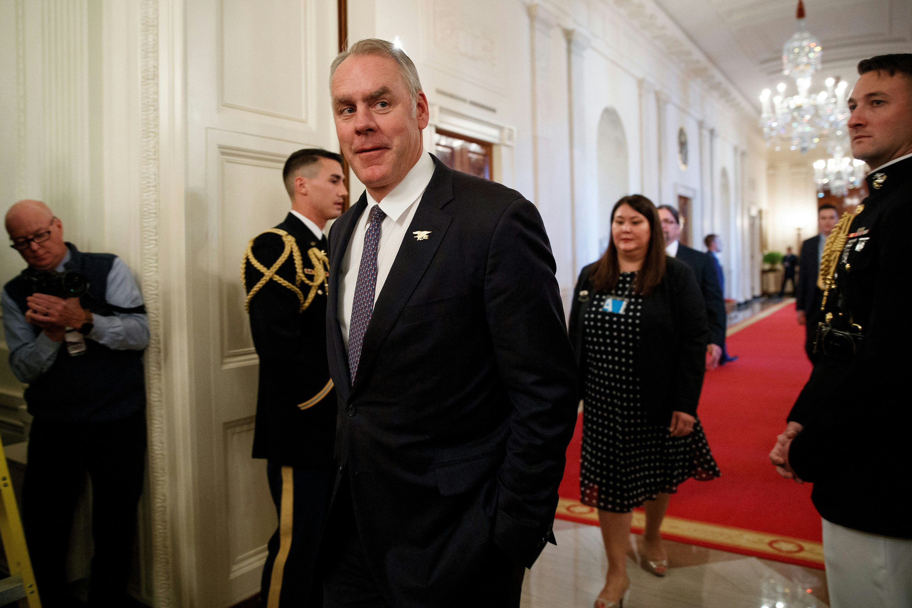 FILE - In this Oct. 24, 2018 file photo, Secretary of the Interior Ryan Zinke arrives for an event with President Donald Trump on the opioid crisis in the East Room of the White House in Washington. Zinke says he’s “100 percent confident” no wrongdoing will be found in pending ethics investigations that have stirred speculation he could get ousted from Trump’s cabinet. (AP Photo/Evan Vucci, File)
