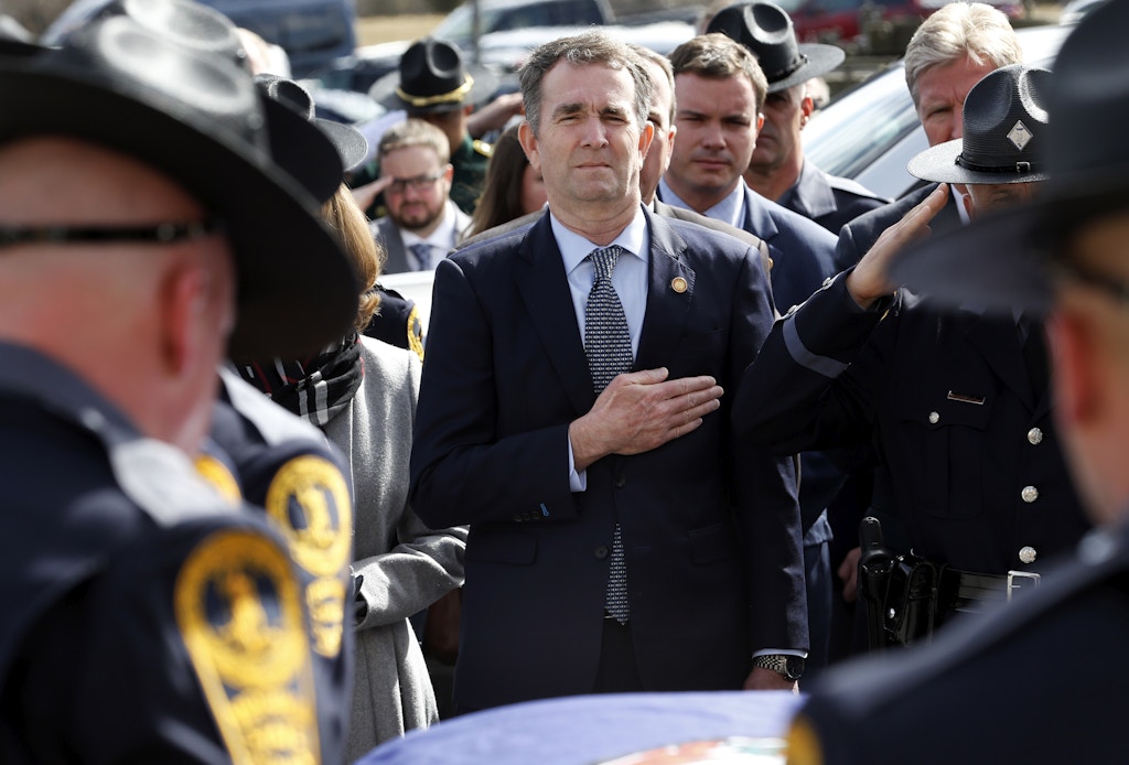 CHILHOWIE, VIRGINIA - FEBRUARY 09: Virginia Gov. Ralph Northam watches as the casket of fallen Virginia State Trooper Lucas B. Dowell is carried to a waiting tactical vehicle during the funeral at the Chilhowie Christian Church  on February 9, 2019 in Chilhowie, Virginia. (Photo by Steve Helber - Pool/Getty Images)