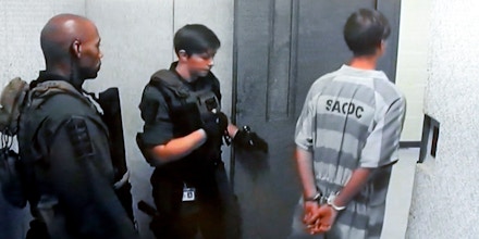 NORTH CHARLESTON, SC - JUNE 19:  In this image from the video uplink from the detention center to the courtroom, Dylann Roof leaves a hearing at Centralized Bond Hearing Court June 19, 2015 in North Charleston, South Carolina. Roof is charged with nine counts of murder and firearms charges in the shooting deaths at Emanuel African Methodist Episcopal Church in Charleston, South Carolina on June 17. (Photo by Grace Beahm-Pool/Getty Images)