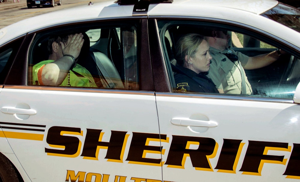 Moultrie County Sheriff deputies transport Michael McWhorter to the Federal Courthouse in Urbana, Ill., Wednesday March 21, 2018. McWhorter is one of three suspects arrested last week on charges of carry out the Aug. 5 pipe-bomb assault on the Dar Al-Farooq Islamic Center in Bloomington, Minnesota. (Rick Danzl/The News-Gazette via AP)