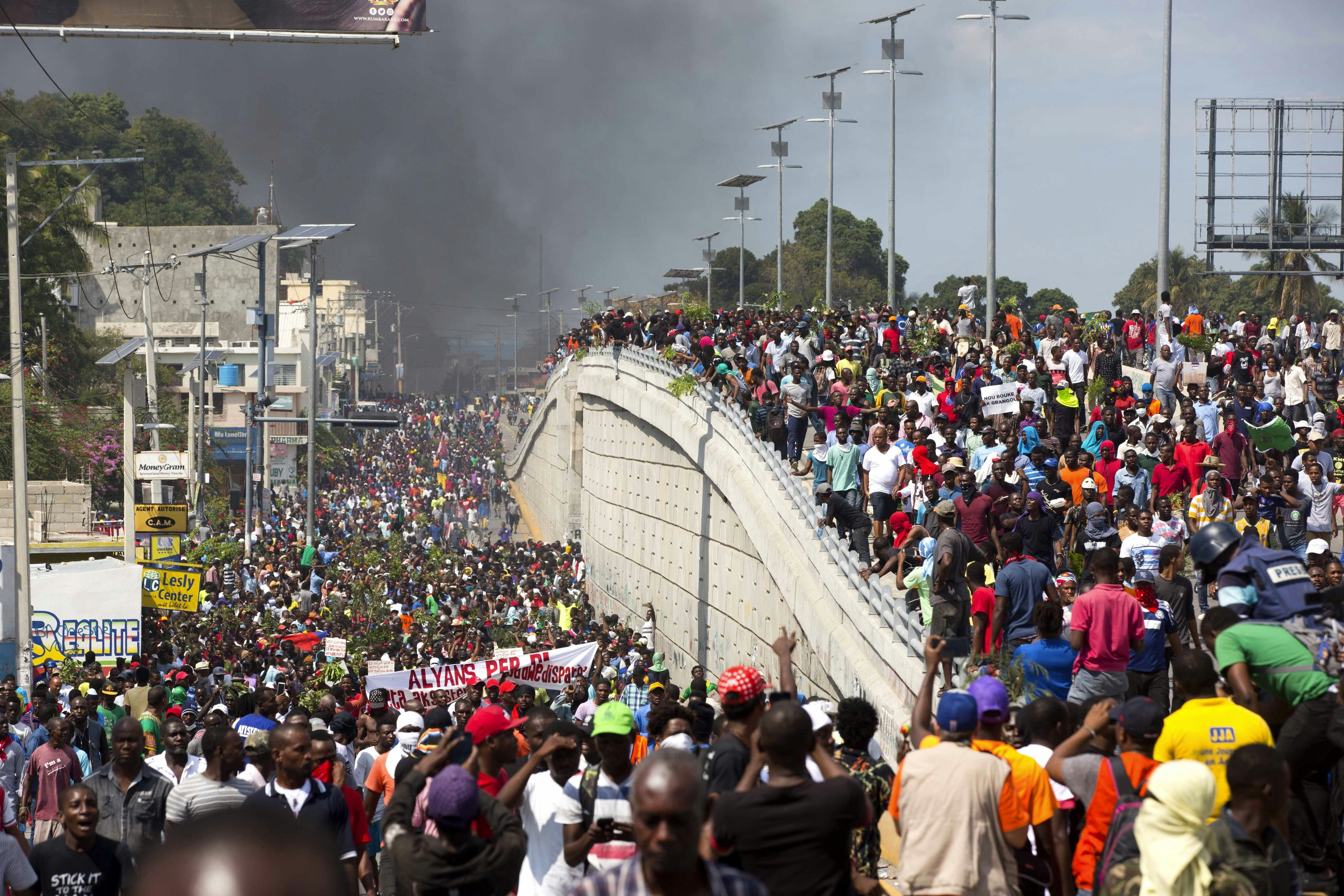 Thousands of demonstrators march in the street as they chant anti-government slogans during a protest to demand the resignation of President Jovenel Moise and demanding to know how Petro Caribe funds have been used by the current and past administrations, in Port-au-Prince, Haiti, Thursday, Feb. 7, 2019. Much of the financial support to help Haiti rebuild after the 2010 earthquake comes from Venezuela's Petro Caribe fund, a 2005 pact that gives suppliers below-market financing for oil and is under the control of the central government. (AP Photo/Dieu Nalio Chery)