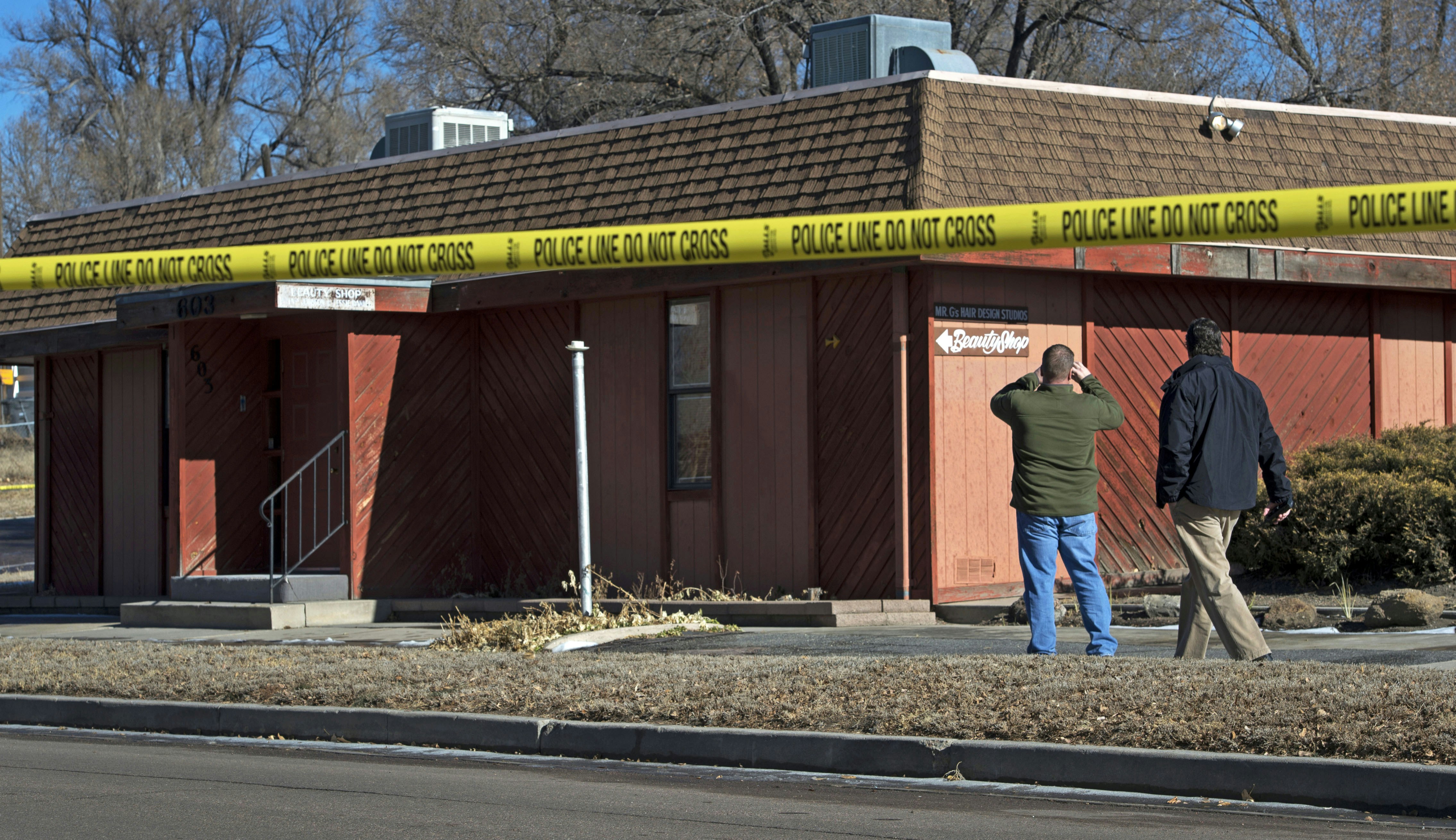 FILE - In this Jan. 6, 2015 file photo, Colorado Springs, Colo., police officers investigate the scene of an explosion at a building in Colorado Springs that houses a barber shop and the Colorado Springs chapter of the NAACP. (AP Photo/The Colorado Springs Gazette, Christian Murdock, File