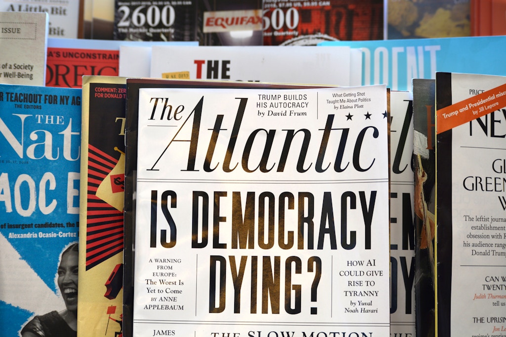 SAN FRANCISCO, CALIFORNIA - SEPTEMBER 16, 2018: A rack of magazines, including The Atlantic, on display in a bookstore in San Francisco, California. The Atlantic cover story promo asks 'Is Democracy Dying?' In 2017, billionaire investor and philanthropist Laurene Powell Jobs, widow of Steve Jobs,  acquired majority ownership of the magazine. (Photo by Robert Alexander/Getty Images)