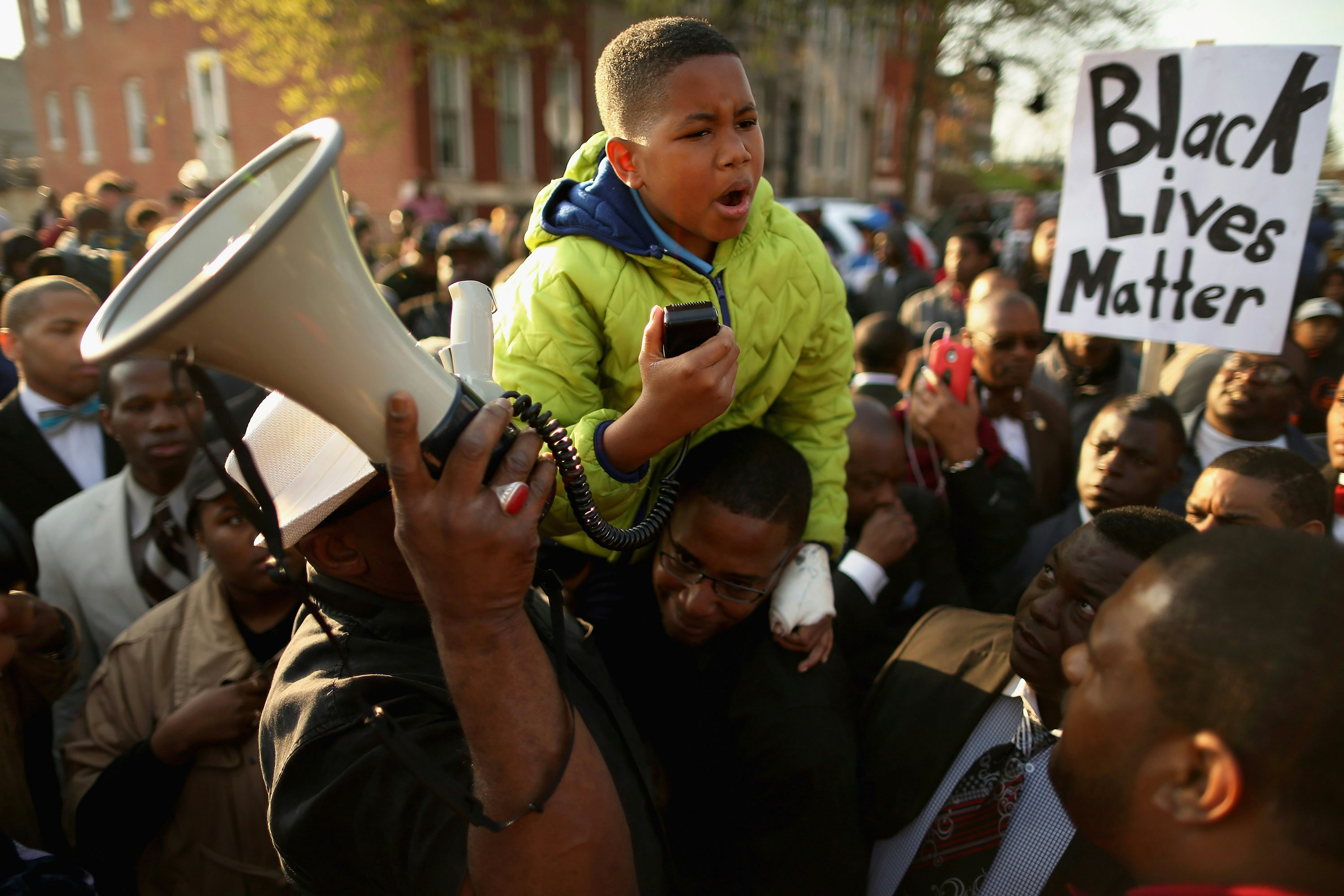 BALTIMORE, MD - APRIL 22:  Ten-year-old Robert Dunn uses a megaphone to address hundreds of demonstrators during a protest against police brutality and the death of Freddie Gray outside the Baltimore Police Western District station April 22, 2015 in Baltimore, Maryland. Gray, 25, was arrested for possessing a switch blade knife April 12 outside the Gilmor Homes housing project on Baltimore's west side. According to his attorney, Gray died a week later in the hospital from a severe spinal cord injury he received while in police custody.  (Photo by Chip Somodevilla/Getty Images)
