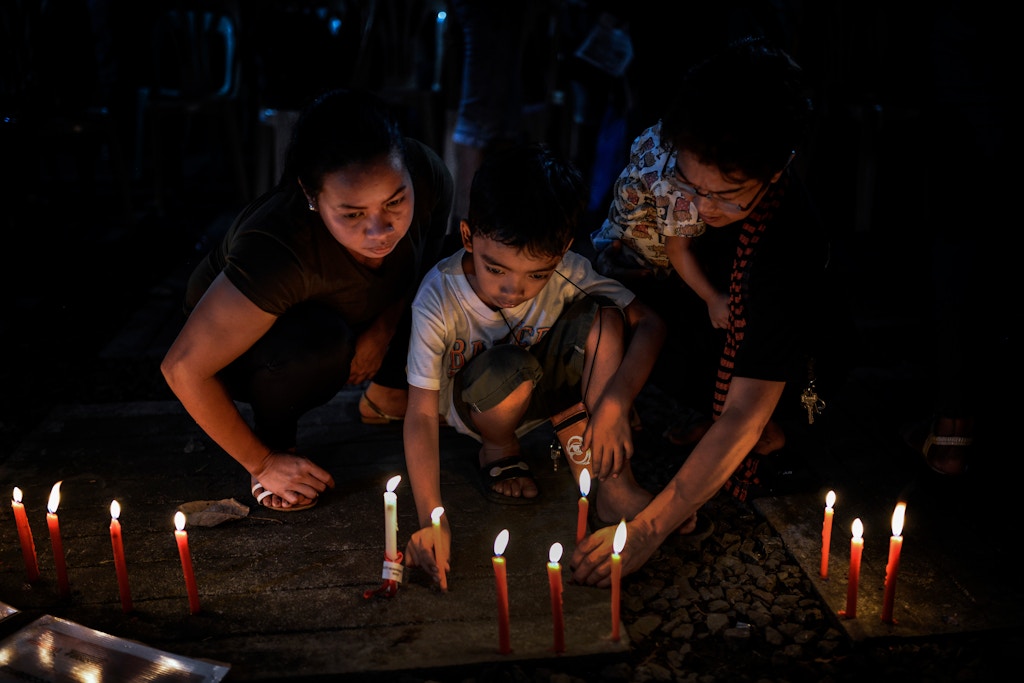 Relatives of victims of extrajudicial killings light candles next to pictures of their loved ones during a vigil in Quezon city, Metro Manila, Philippines, December 1, 2017. On International Human Rights Day, thousands of Philippine President Rodrigo Duterte's critics marched the streets to condemn what they say are the many human rights violations under his watch. The protests come in light of the recent killings of activist leaders and indigenous peoples, the alleged human rights abuses by the military during the siege of Islamic State militants in Marawi, the thousands killed in the government's deadly campaign against illegal drugs, and Duterte's proclamation labeling communist rebels and left-wing groups as terrorists. Photo: Ezra Acayan/NurPhoto (Photo by Ezra Acayan/NurPhoto via Getty Images)