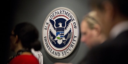 The U.S. Immigration and Customs Enforcement (ICE) seal hangs on a wall before a speech by U.S. Vice President Mike Pence, not pictured, at the agency headquarters in Washington, D.C., U.S., on Friday, July 6, 2018. The U.S. will return immigrant children under five who were separated from their parents after crossing the Mexican border by July 10 to comply with a court order, the Health and Human Services Secretary said Thursday. Photographer: Andrew Harrer/Bloomberg via Getty Images