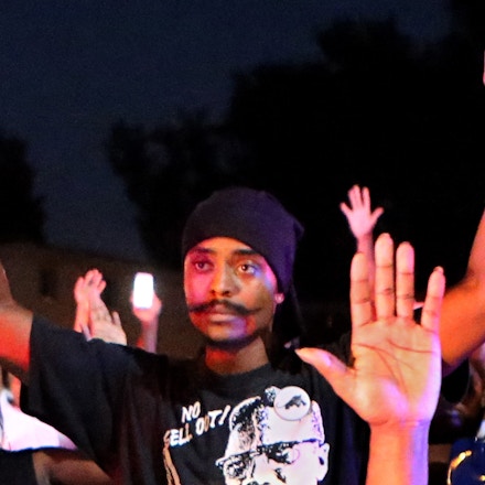 Olajuwon Ali Davis (center) stands with his hands up on Canfield Drive in Ferguson as the crowd confront police on the night of Aug. 9 hours after Michael Brown was shot and killed by Ferguson Police officer Darren Wilson. Davis one one of two men charged with federal weapons charges, and who also allegedly had plans to bomb the Gateway Arch, and to kill St. Louis County Prosecuting Attorney Robert McCulloch and Ferguson Police Chief Tom Jackson. Photo By David Carson, dcarson@post-dispatch.com s one one of two men charged last week with federal weapons charges, and who also allegedly had plans to bomb the Gateway Arch, and to kill St. Louis County Prosecuting Attorney Robert McCulloch and Ferguson Police Chief Tom Jackson. (David Carson/Post Dispatch/Polaris) ///