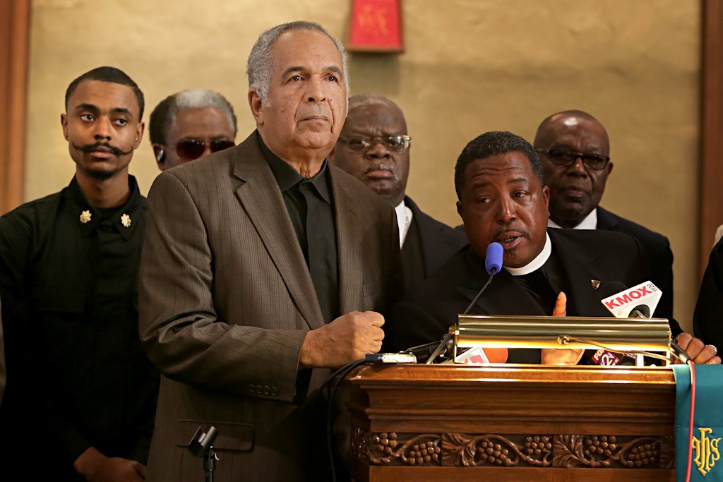 Pastor Spencer Booker, of the St. Paul A.M.E. Church, addresses the crowd at a press conference where a boycott and protest of Black Friday shopping was announced by the Justice for Michael Brown Leadership Coalition in St. Louis on Wednesday, Nov. 12, 2104. In addition to the boycott leaders called for mass demonstrations at shopping centers. Pictured to the far left is Olajuwon Ali Davis who is one one of two men charged last week with federal weapons charges, and who also allegedly had plans to bomb the Gateway Arch, and to kill St. Louis County Prosecuting Attorney Robert McCulloch and Ferguson Police Chief Tom Jackson. (David Carson/Post Dispatch/Polaris) ///