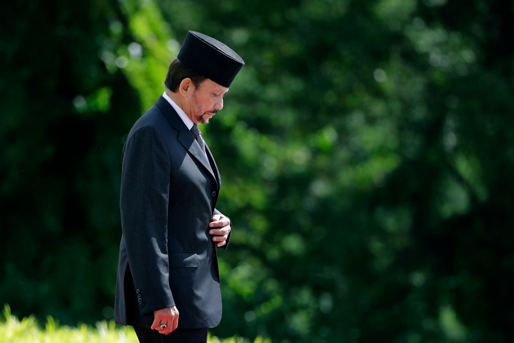 Brunei's Sultan Hassanal Bolkiah proceeds to inspect honor guards during a welcome ceremony at the Istana on Wednesday, July 5, 2017, in Singapore. (AP Photo/Wong Maye-E)