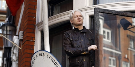 FILE- In this Friday May 19, 2017 file photo, WikiLeaks founder Julian Assange greets supporters outside the Ecuadorian embassy in London. Britain's Foreign Office said Thursday, Jan. 11, 2018 it has rejected Ecuador's request to grant diplomatic status to Assange, who has been living in the nation's embassy in London since 2012 to avoid arrest by U.K. authorities. (AP Photo/Frank Augstein, File)