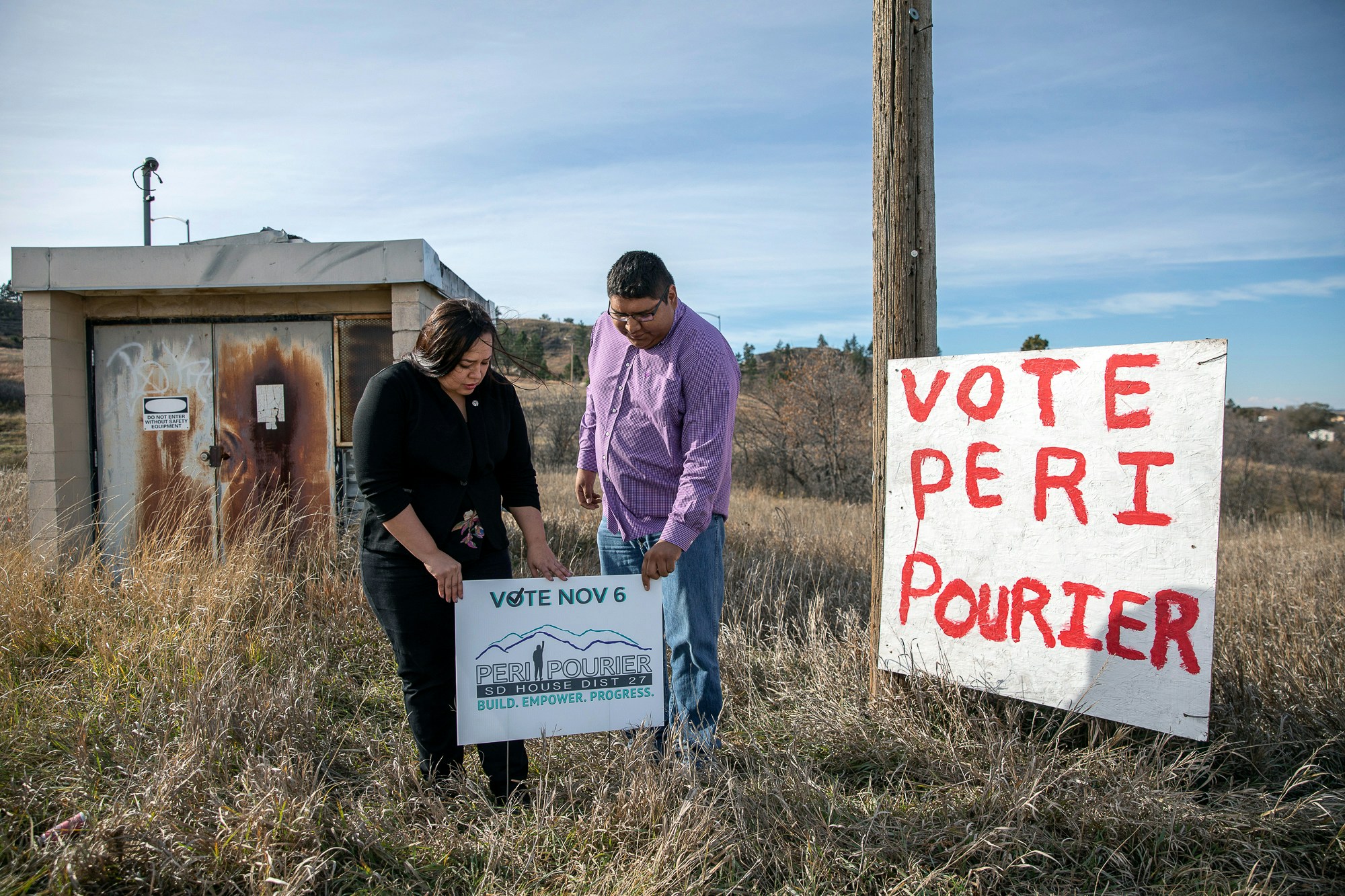 In this Wednesday, Oct. 24, 2018 photo, Peri Pourier, a candidate for the South Dakota Legislature, and her partner, Ernest Weston, stand for a portrait in Porcupine, S.D., on the Pine Ridge Indian Reservation. As with state and municipal races across the country, elections for tribal candidates on the Pine Ridge reservation are in full swing for the Nov. 6 election. (Ryan Hermens/Rapid City Journal via AP)
