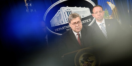 US Deputy Attorney General Rod Rosenstein (R) listens while Attorney General William Barr speaks during a press conference about the release of the Mueller Report at the Department of Justice April 18, 2019, in Washington, DC. - US Attorney General Bill Barr said Thursday that the White House fully cooperated with Special Counsel Robert Mueller's probe of Russian election meddling and that President Donald Trump took no action to thwart the probe. 
