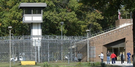 Employees walk in the yard of Muskegon Correctional Facility in Muskegon, Mich., on Oct. 4, 2012.