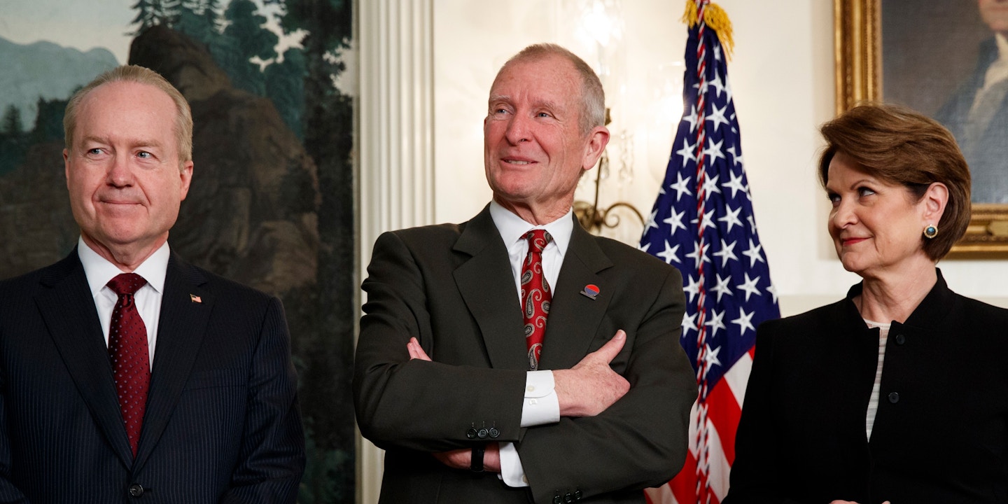 Raytheon CEO Tom Kennedy, left, former Director of National Intelligence Dennis Blair, center, and Lockheed Martin CEO Marillyn Hewson wait for the arrival of President Donald Trump to an event announcing tariffs and investment restrictions on China, in the Diplomatic Reception Room of the White House, Thursday, March 22, 2018, in Washington. (AP Photo/Evan Vucci)