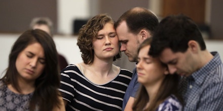 Abigail and Jonathan Dysinger, center, pray during a vigil for Donnie Johnson, Thursday, May 16, 2019, in Nashville, Tenn. Johnson was executed by lethal injection Thursday for suffocating his wife, Connie Johnson, in a Memphis camping center that he managed in 1984. The vigil was held at Riverside Seventh-Day Adventist Church, where Johnson served as an elder while in prison, even though he was never able to visit the church. (AP Photo/Mark Humphrey)