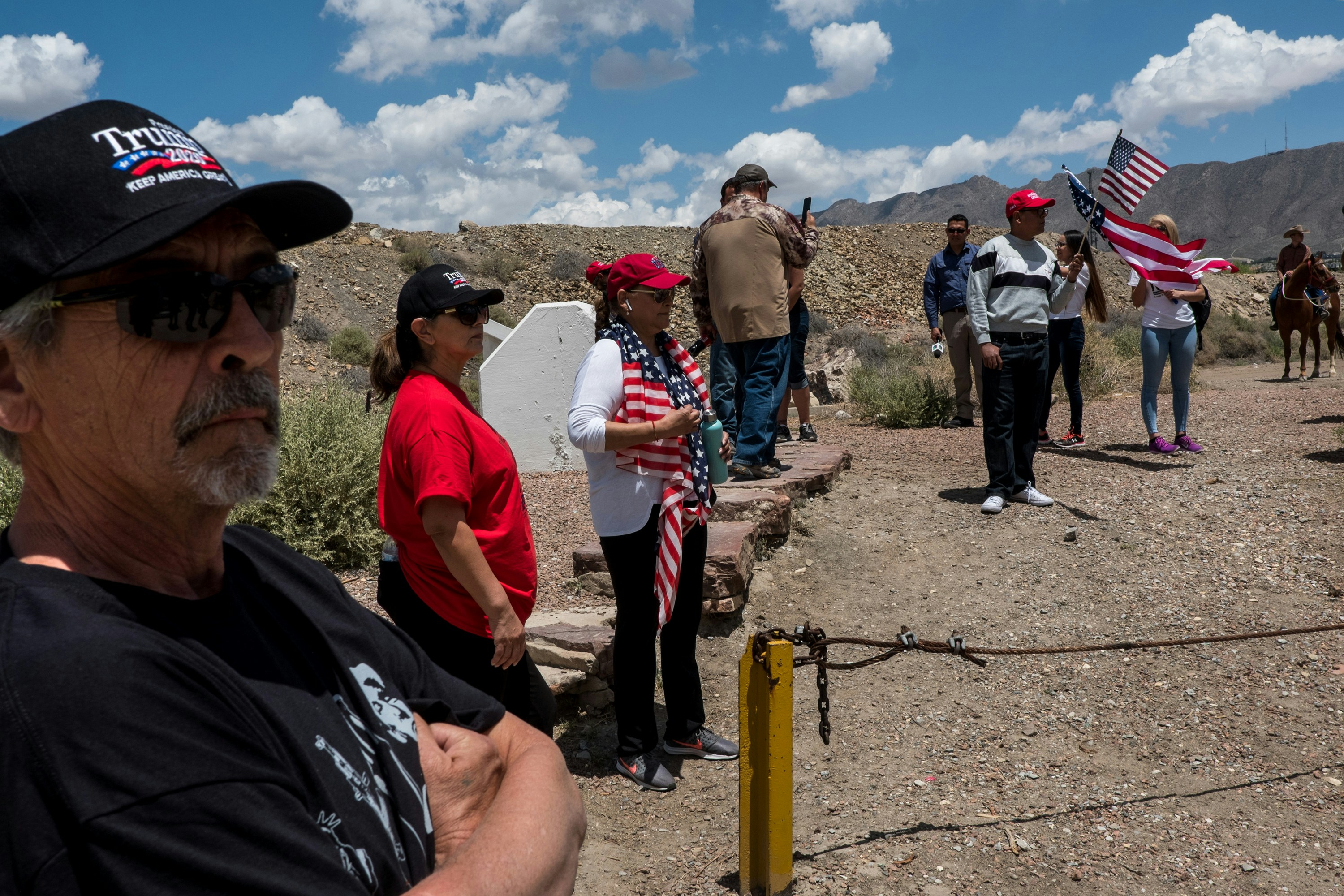 Sam Esquivel, left, Nancy Esquivel and Jacqueline Torres gather near Monument One at the U.S.-México border on the outskirts of Sunland Park, New Mexico, Saturday, May 11, 2019. (Joel Angel Juárez for The Intercept)