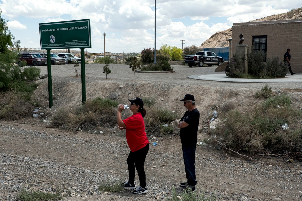 Nancy Esquivel and her husband Sam, both of El Paso, walk nearby the U.S.-México border on the outskirts of Sunland Park, New Mexico, Saturday, May 11, 2019. Both had crossed into México and back without being apprehended by officials on either side. (Joel Angel Juárez for The Intercept)