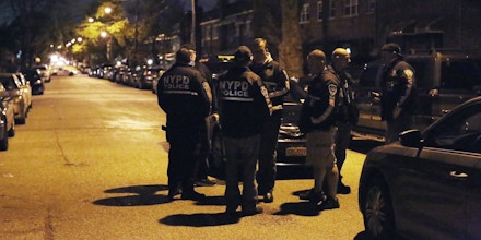 In this photo provided by the New York City Police Department, officers gather at a location in the Bronx borough of New York during a takedown of two rival drug gangs in the early hours of Wednesday, April 27, 2016. According to the U.S. Attorney, nearly 700 New York Police Department officers and federal agents accompanied by helicopters and armored trucks executed pre-dawn raids, taking down the rival drug gangs from top to bottom. (New York Police Department via AP)