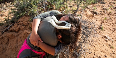 Alexandria hugs her younger sister Semira, both part of the extended James family, on Navajo land in Salina Springs, Ariz., May 12, 2019. The girls have two younger siblings whose fate is at stake in a legal battle over a federal law that prioritizes placing Native American children in state foster care with Native families, to reinforce their tribal identity. (Ilana Panich-Linsman/The New York Times)