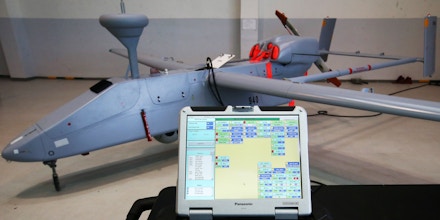 YEKATERINBURG, RUSSIA. FEBRUARY 12, 2016. A Panasonic laptop computer running a programme, with a Forpost unmanned aerial vehicle (UAV, drone) behind at UWCA Ural Works of Civil Aviation. JSC Ural Works of Civil Aviation (UWCA) is a major aircraft repair company offering repair services for power units of helicopters designed by MIL Moscow Helicopter Plant and Kamov. Anton Novoderezhkin/TASS (Photo by Anton NovoderezhkinTASS via Getty Images)