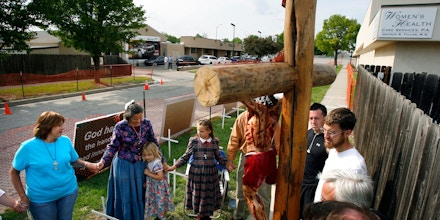 About a dozen abortion opponents gather in front of Dr. George Tiller's clinic in Wichita, Kan., Thursday, May 17, 2007, to launch a 77-hour prayer vigil. (AP Photo/Larry W. Smith)