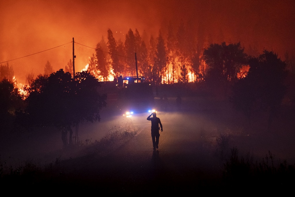 Emergency personnel work to extinguish a wildfire near Cardigos village, central Portugal on Sunday, July 21, 2019. Portugal, a victim of its poor forest management, has long been the southern European country where most wildfires occur. Climate change has become another challenge for the country, bringing hotter, drier and longer summers. (AP Photo/Sergio Azenha)