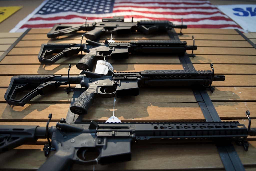 Assault rifles hang on the wall for sale at Blue Ridge Arsenal in Chantilly, Virginia, on October 6, 2017. / AFP PHOTO / JIM WATSON        (Photo credit should read JIM WATSON/AFP/Getty Images)