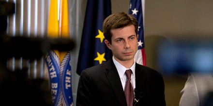 South Bend mayor Pete Buttigieg listens to a question during a news conference announcing deputy coroner Chuck Hurley as the interim South Bend Police Department chief on Friday, March 30, 2012, in the mayor's downtown office in South Bend, Ind. Buttigieg said Darryl Boykins, former city police chief resigned as federal investigators are looking into the wiretapping of police department phones.  (AP Photo/South Bend Tribune, James Brosher)