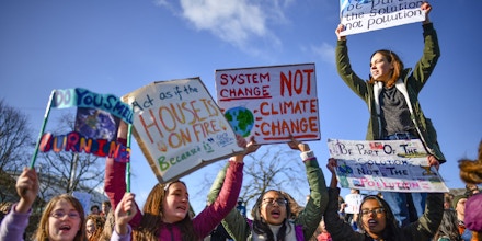 School children hold placards and shout slogans as they participate in the Strike for Climate Change protest outside the Scottish Parliament in Edinburgh, Scotland on March 15, 2019.