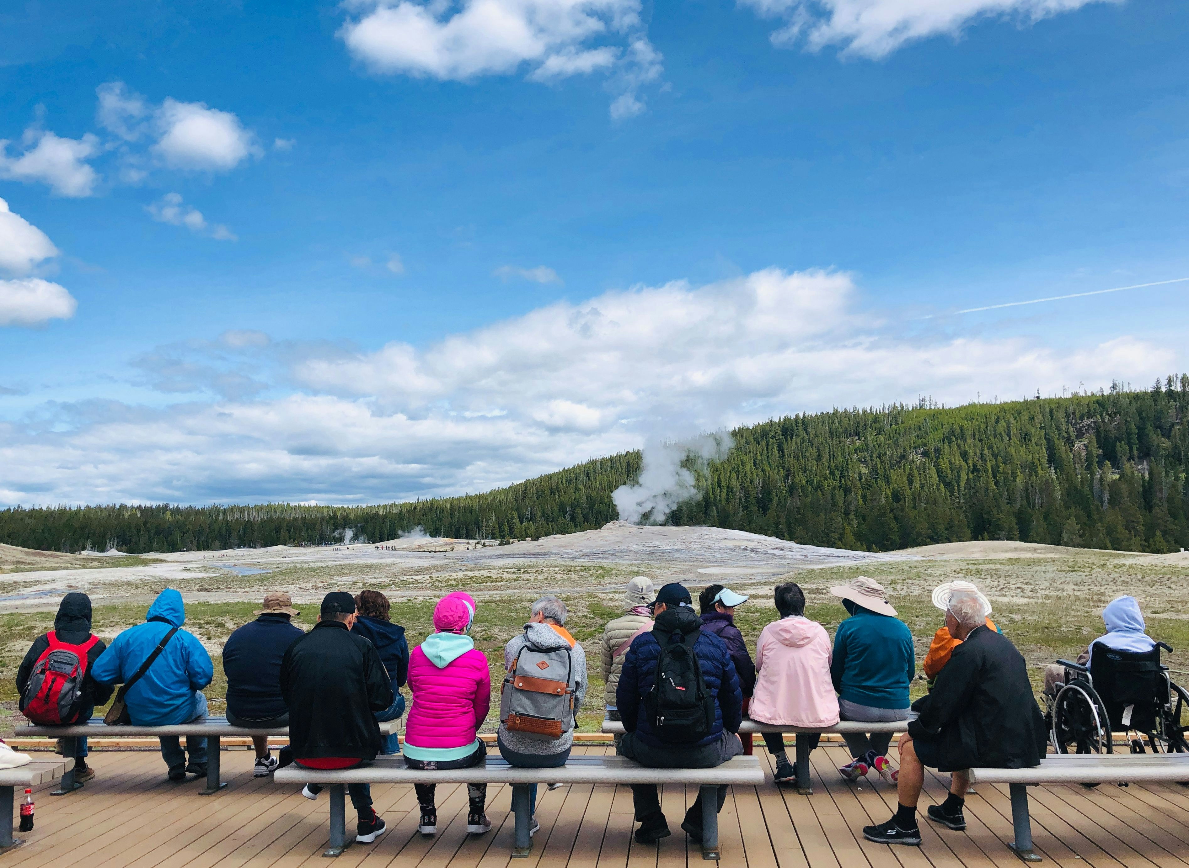 Tourists wait for the eruption of Old Faithful geyser in Yellowstone National Park in Wyoming on June 11, 2019. - Old Faithful has erupted every 44 to 125 minutes since 2000. (Photo by Daniel SLIM / AFP)