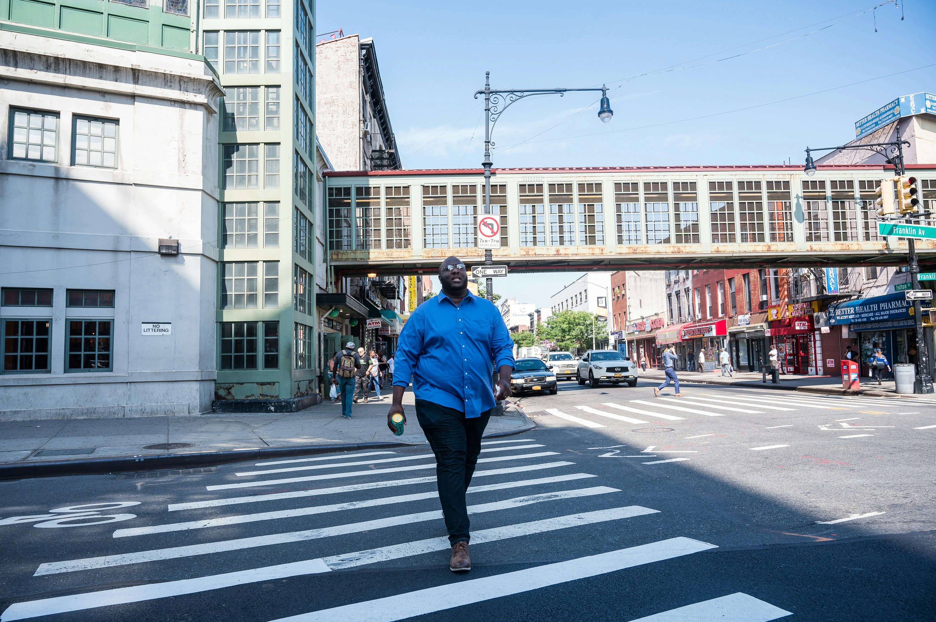 James walks along Fulton Street, a major thoroughfare that divides the Brooklyn neighborhoods of  Clinton Hill and Prospect Heights , on August 19, 2019.