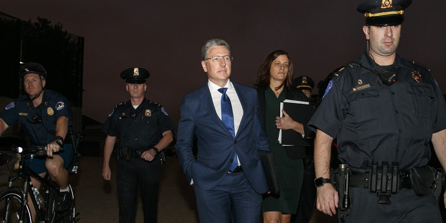 Kurt Volker, center, a former special envoy to Ukraine, is escorted as he leaves a closed-door interview with House investigators at the Capitol, Thursday, Oct. 3, 2019, in Washington. (AP Photo/Jacquelyn Martin)