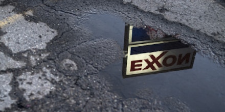 Exxon Mobil Corp. signage is reflected in a puddle at a gas station in Nashport, Ohio, U.S., on Friday, Jan. 26, 2018. Exxon Mobil Corp. is scheduled to release earnings figures on February 2. Photographer: Ty Wright/Bloomberg via Getty Images
