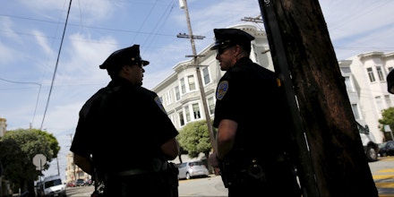 San Francisco police officers stand on Lombard Street, a popular tourist spot also known as the 