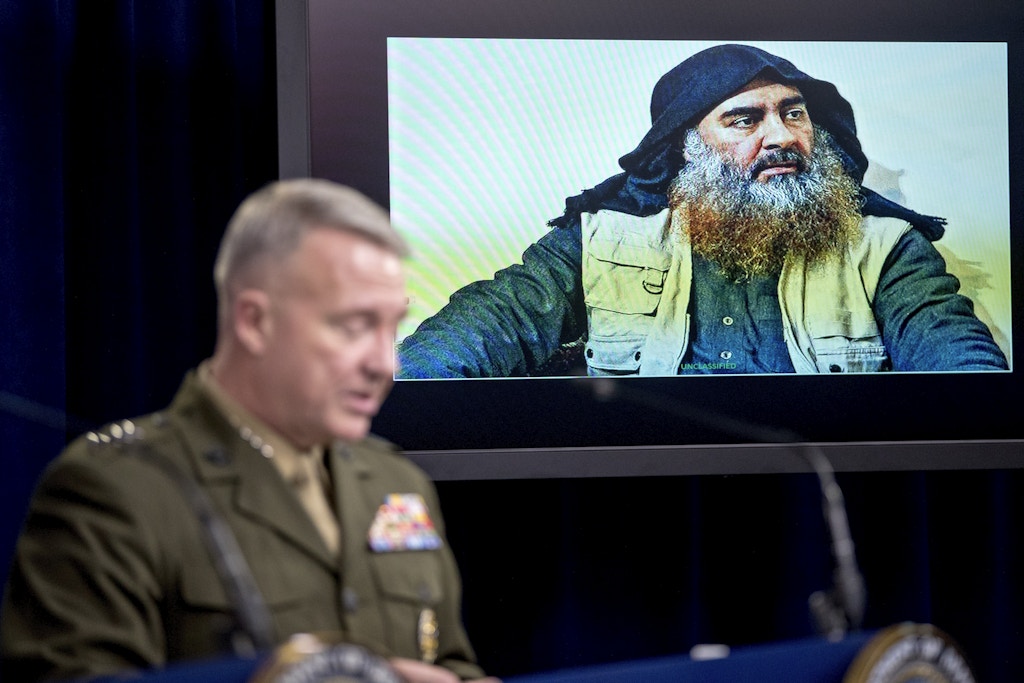 Abu Bakr al-Baghdadi is displayed on a monitor as U.S. Central Command Commander Marine Gen. Kenneth McKenzie at a joint press briefing at the Pentagon in Washington, Wednesday, Oct. 30, 2019, on the Abu Bakr al-Baghdadi raid. (AP Photo/Andrew Harnik)