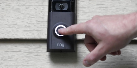 FILE - In this July 16, 2019, file photo, Ernie Field pushes the doorbell on his Ring doorbell camera at his home in Wolcott, Conn. Amazon says it has considered adding facial recognition technology to its Ring doorbell cameras. The company said in a letter released Tuesday, Nov. 19 by U.S. Sen. Ed Markey that facial recognition is a “contemplated, but unreleased feature” of its home security cameras. The Massachusetts Democrat wrote to Amazon CEO Jeff Bezos in September raising privacy and civil liberty concerns about Ring’s video-sharing partnerships with hundreds of police departments around the country.   (AP Photo/Jessica Hill, File)