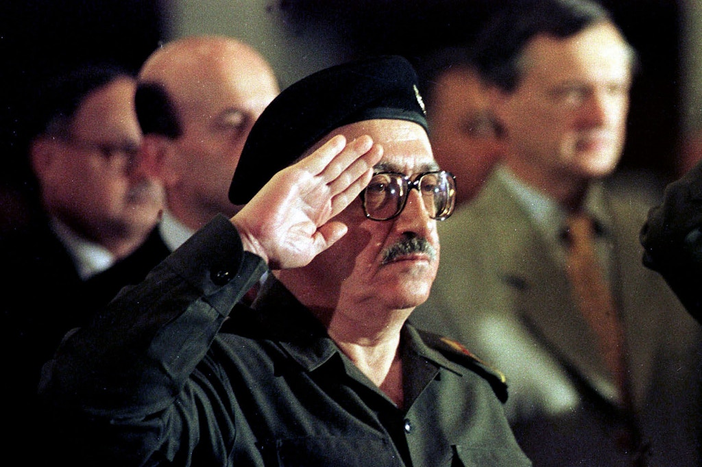 FILE - In this Dec. 2, 1998 file photo, former Iraqi foreign minister Tariq Aziz stands to attention as the Iraqi national anthem is played at a conference in Baghdad, Iraq. Officials say Aziz has died in a hospital in southern Iraq on Friday, June 5, 2015.  (AP Photo/Peter Dejong, File)