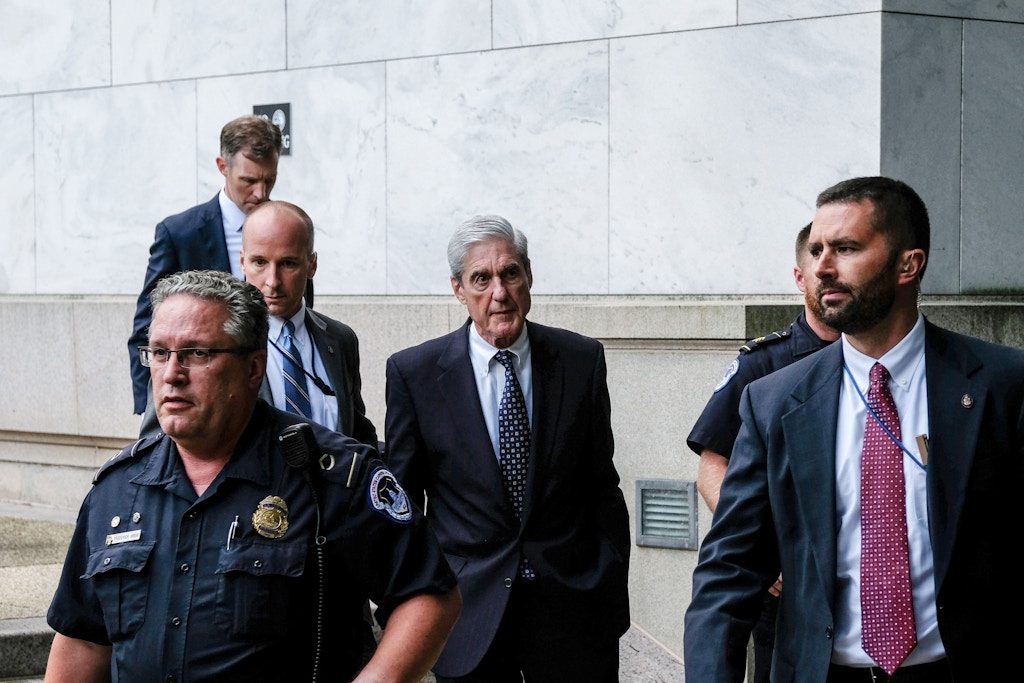 WASHINGTON, DC - JULY 24: Former Special Counsel Robert Mueller (C) departs after testifying to the House Intelligence Committee about his report on Russian interference in the 2016 presidential election on Capitol Hill on July 24, 2019 in Washington, DC. Mueller earlier testified before the House Judiciary Committee in back-to-back hearings on Capitol Hill. (Photo by Alex Wroblewski/Getty Images)