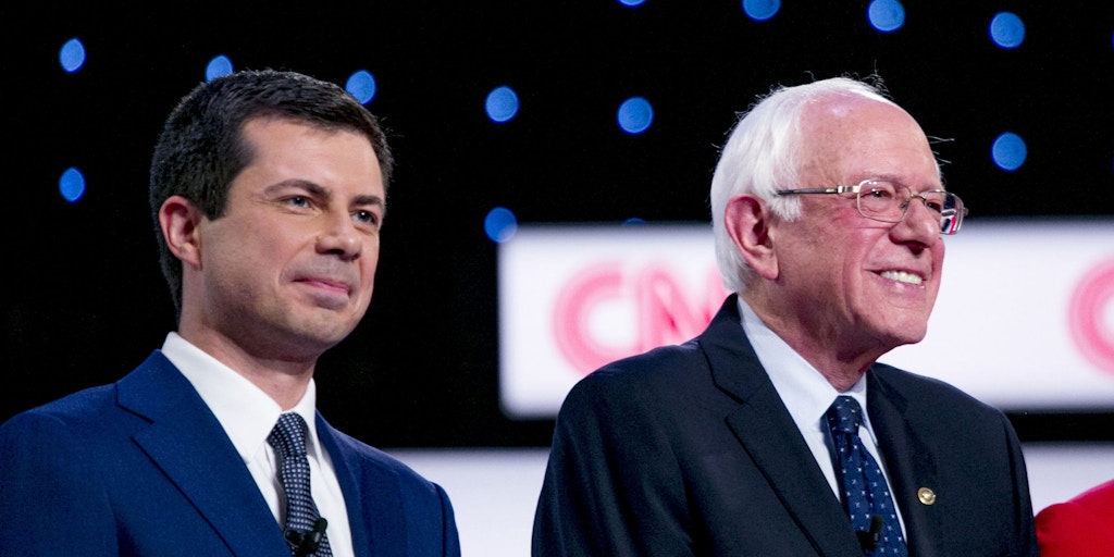 2020 Democratic Presidential Candidates Pete Buttigieg, mayor of South Bend, left to right, Senator Bernie Sanders, an independent from Vermont, and Senator Elizabeth Warren, a Democrat from Massachusetts, stand on stage during the Democratic presidential candidate debate in Detroit, Michigan, U.S., on Tuesday, July 30, 2019. The question of what it will take to defeat President Donald Trump next year took center stage at the Democratic debate as moderate rivals to Warren and Sanders argued their promises of sweeping, fundamental change are unrealistic and will drive voters to the GOP. Photographer: Anthony Lanzilote/Bloomberg via Getty Images