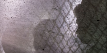 MCALLEN, TEXAS - AUGUST 12:Shadow silhouettes of minors awaiting processing are seen on the floor of the US Border Patrol Central Processing Center in McAllen, Texas on August 12, 2019. Border Patrol officials said that 1,267 people were being held and processed in the facility at the time of the tour. (Photo by Carolyn Van Houten/The Washington Post via Getty Images)