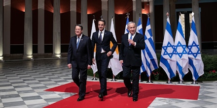 Greece's Prime Minister Kyriakos Mitsotakis, center, Cypriot President Nicos Anastasiadis, left, and Israeli Prime Minister Benjamin Netanyahu walk towards a hall for a signing ceremony in Athens, Thursday, Jan. 2, 2020. The leaders of Greece, Israel and Cyprus met in Athens Thursday to sign a deal aiming to build a key undersea pipeline, named EastMed, designed to carry gas from new rich offshore deposits in the southeastern Mediterranean to continental Europe. (AP Photo/Yorgos Karahalis)