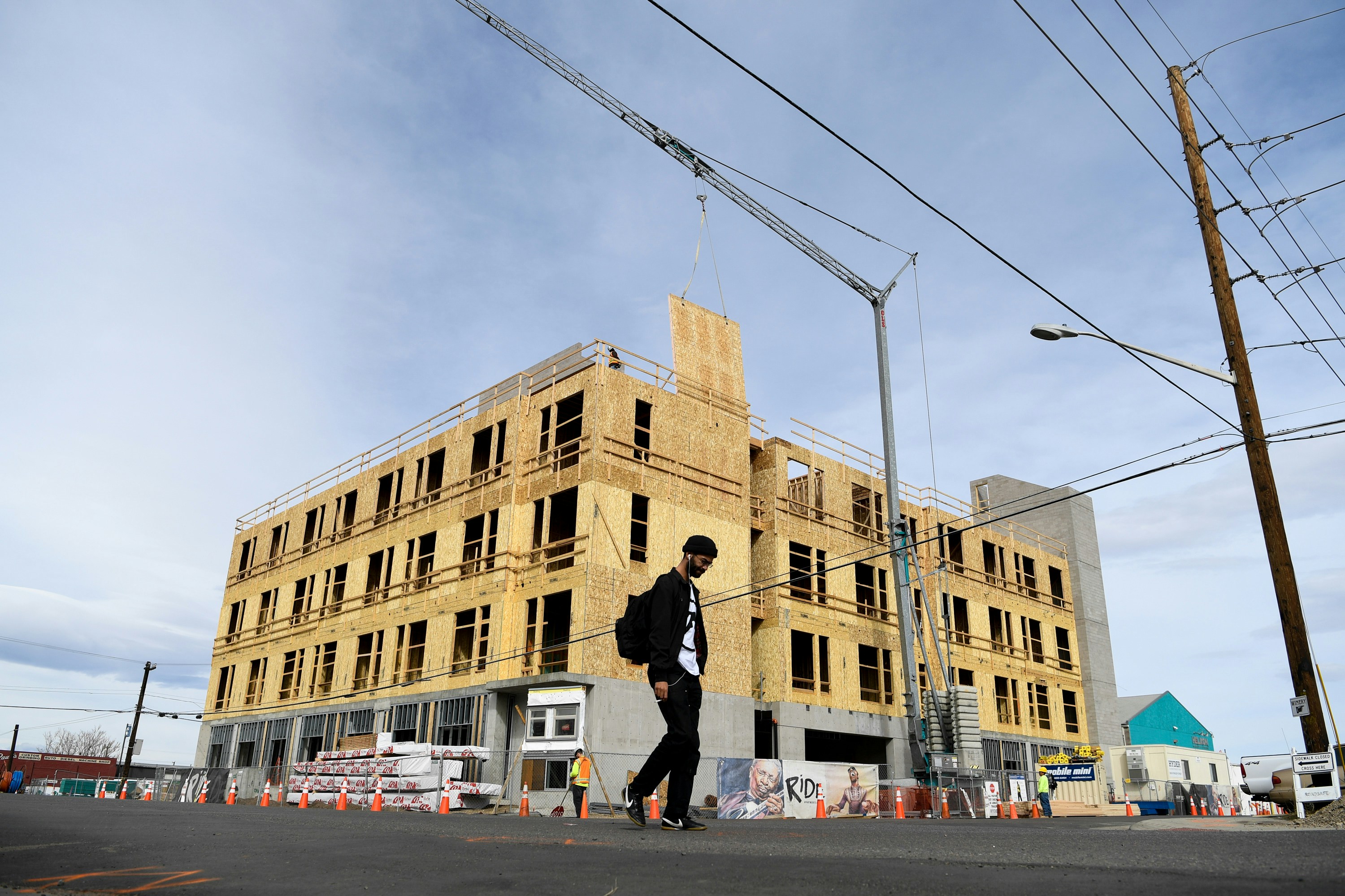 DENVER, CO - FEBRUARY 8: Kahlil Zawadi walks near 36th and Wynkoop in front of a construction on Thursday, February 8, 2018. On Monday night, Denver City Council is poised to approve a long-formulated zoning proposal for the 38th/Blake transit station area that, for the first time in the city's history, will allow developers to build even higher than regular zoning allows  up to 16 stories in some places  as long as they provide more affordable housing as part of their projects. Some developers are eyeing potential projects that would take advantage of this, but they cannot get started until this is passed.(Photo by AAron Ontiveroz/The Denver Post via Getty Images)