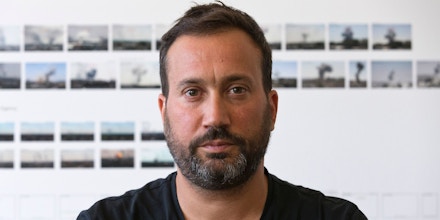 Principal Investigator Eyal Weizman poses for a photograph in his office at Goldsmiths, University in London on August 26, 2016.Human rights campaigners Amnesty International are the latest organisation to call on Forensic Architecture's (FA) expertise. Its interdisciplinary laboratory specialises in producing analysis and evidence to be used in human rights cases brought to international courts, with architecture a key tool in helping to accurately recreate events occurring in chaotic surroundings. / AFP / JUSTIN TALLIS / TO GO WITH AFP STORY BY MYRIAM BENEZZAR (Photo credit should read JUSTIN TALLIS/AFP via Getty Images)