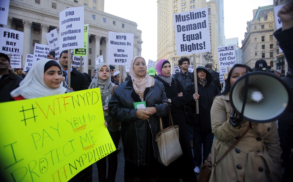 Muslim community and supporters protest the NYPD  surveillance operations of Muslim communities during a rally in Foley Square on Friday, Nov. 18, 2011, in New York.  Hundreds of Muslims gathered in prayer Friday to oppose a decade of police spying on Muslim communities. The crowd filled about three-fourths of Foley Square in lower Manhattan, not far from City Hall. Demonstrators were scheduled to march on police headquarters. (AP Photo/Bebeto Matthews)